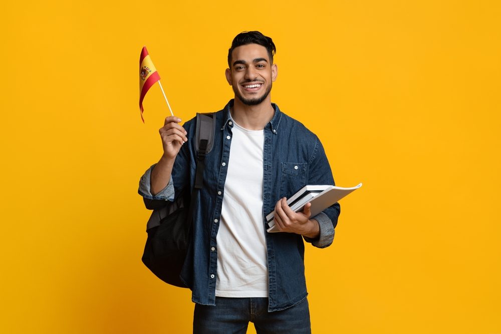 International student holding the Spanish flag