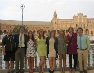 SAIIE students smiling and embracing in front of Plaza de España in Seville, Spain