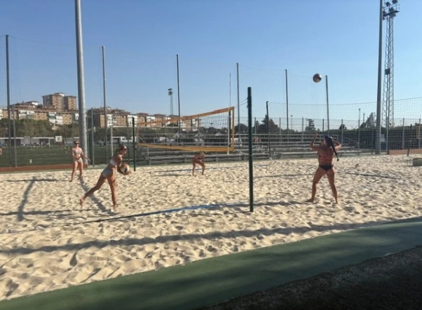 Students at beach volleyball practice with Spanish local team